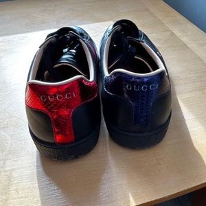 Black, red, and blue men’s Gucci shoes